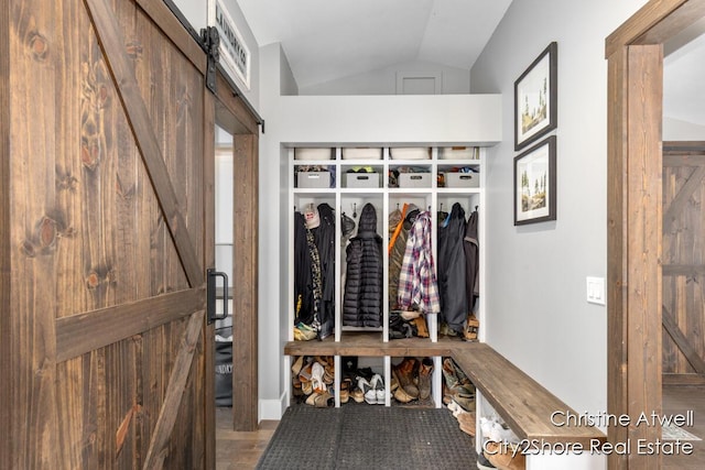 1495 Yeckley Rd, Hastings, MI 49058 - mudroom featuring a barn door, lofted ceiling, and wood finished floors