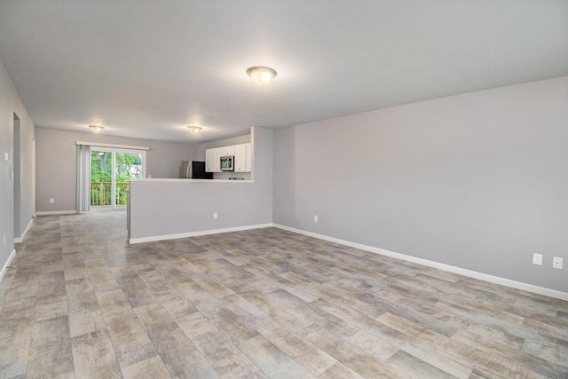 7216 Heartwood Ct, Portage, MI 49002 - unfurnished living room with light wood-type flooring