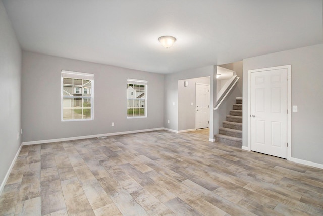 7216 Heartwood Ct, Portage, MI 49002 - unfurnished room featuring stairway and light wood-style flooring
