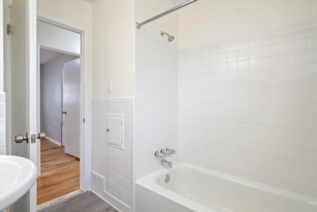 7710 Pelham Rd, Taylor, MI 48180 - full bathroom featuring wood finished floors, shower / washtub combination, and tile walls