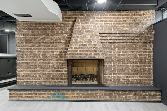 7710 Pelham Rd, Taylor, MI 48180 - detailed view of wood finished floors, a brick fireplace, and brick wall