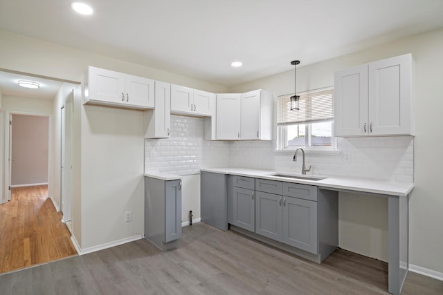 7710 Pelham Rd, Taylor, MI 48180 - kitchen featuring gray cabinetry, light wood-style flooring, backsplash, and recessed lighting