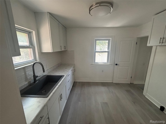 910 Spence St, Southfield, MI 48340 - kitchen with plenty of natural light, light wood-type flooring, tasteful backsplash, and light stone countertops