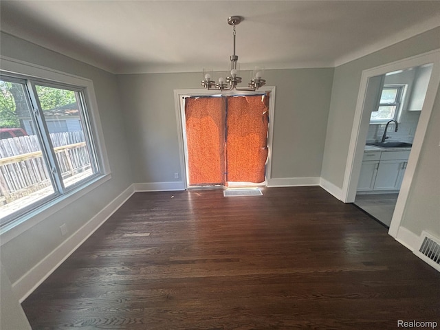 910 Spence St, Southfield, MI 48340 - unfurnished dining area with a chandelier and dark wood-style floors