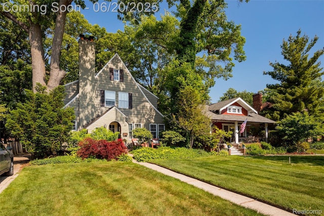 55 Oakdale Blvd, Pleasant Ridge, MI 48069 - view of front of home with a chimney, a front lawn, and a porch