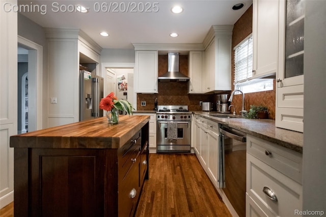 55 Oakdale Blvd, Pleasant Ridge, MI 48069 - kitchen featuring appliances with stainless steel finishes, wood counters, wall chimney exhaust hood, tasteful backsplash, and dark wood-type flooring