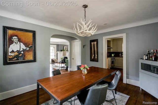 55 Oakdale Blvd, Pleasant Ridge, MI 48069 - dining room featuring arched walkways, dark wood-type flooring, and a chandelier
