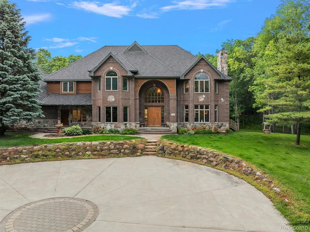 429 Hawk High Hill Rd, Metamora, MI 48455 - view of front of house with a chimney, a front lawn, brick siding, and stone siding