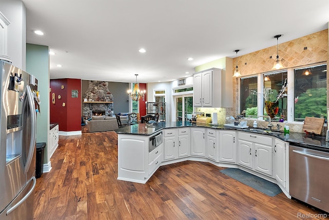 429 Hawk High Hill Rd, Metamora, MI 48455 - kitchen featuring appliances with stainless steel finishes, a peninsula, a chandelier, dark wood-style flooring, and recessed lighting