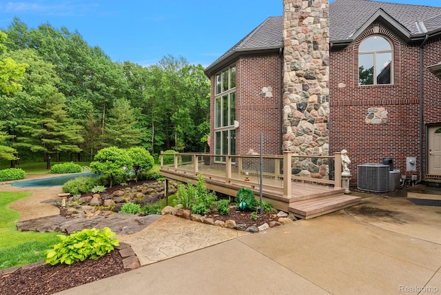 429 Hawk High Hill Rd, Metamora, MI 48455 - back of property featuring a patio area, a wooden deck, brick siding, and a chimney