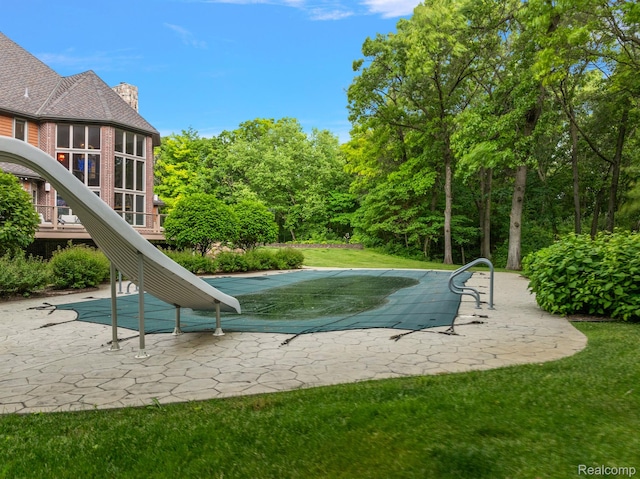 429 Hawk High Hill Rd, Metamora, MI 48455 - view of pool with a water slide, a patio area, a covered pool, and a yard
