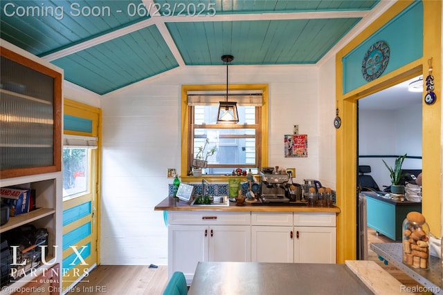 1200 Porter St, Detroit, MI 48226 - kitchen with wooden ceiling, white cabinetry, healthy amount of natural light, wood finished floors, and decorative light fixtures