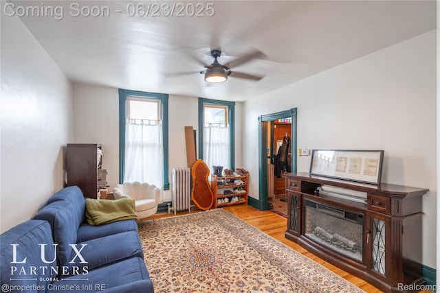 1200 Porter St, Detroit, MI 48226 - living room featuring radiator, light wood-type flooring, and a ceiling fan