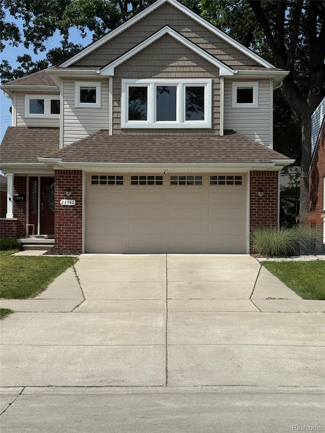 23540 Wilson Ave, Dearborn, MI 48128 - view of front of house with concrete driveway, a garage, and brick siding