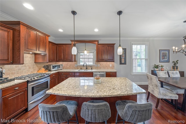 2534 Buckingham Ave, Birmingham, MI 48009 - kitchen with stainless steel appliances, a breakfast bar area, tasteful backsplash, dark wood finished floors, and light stone counters