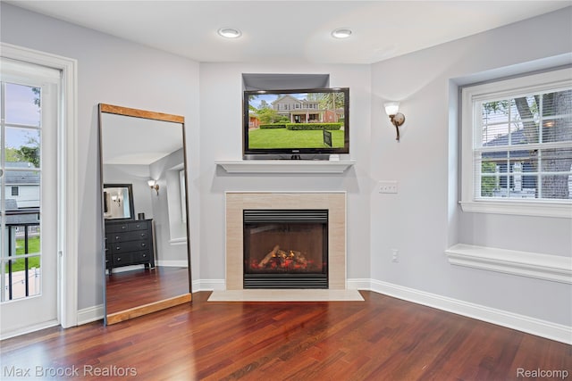 2534 Buckingham Ave, Birmingham, MI 48009 - unfurnished living room featuring wood finished floors, a tiled fireplace, and recessed lighting