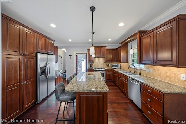 2534 Buckingham Ave, Birmingham, MI 48009 - kitchen featuring appliances with stainless steel finishes, ornamental molding, dark wood-style flooring, a center island, and tasteful backsplash