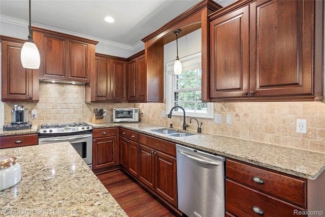 2534 Buckingham Ave, Birmingham, MI 48009 - kitchen featuring appliances with stainless steel finishes, light stone counters, dark wood-type flooring, hanging light fixtures, and crown molding
