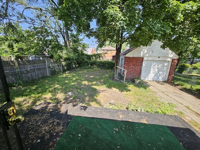 18242 Mendota St, Detroit, MI 48221 - view of yard featuring a garage and driveway