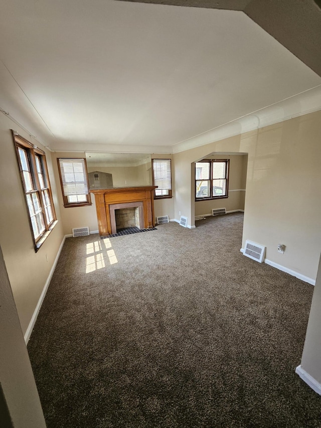 18242 Mendota St, Detroit, MI 48221 - unfurnished living room featuring carpet, plenty of natural light, a fireplace with flush hearth, and crown molding
