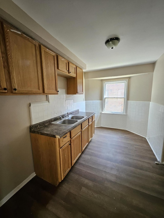 18242 Mendota St, Detroit, MI 48221 - kitchen with dark wood-style floors, dark countertops, a wainscoted wall, brown cabinetry, and decorative backsplash