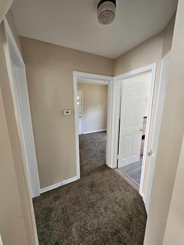 18242 Mendota St, Detroit, MI 48221 - hallway featuring dark carpet and baseboards