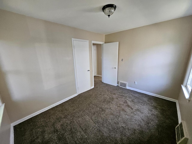 18242 Mendota St, Detroit, MI 48221 - unfurnished room with dark colored carpet and baseboards