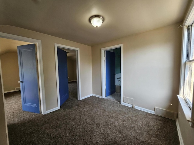 18242 Mendota St, Detroit, MI 48221 - unfurnished bedroom with dark colored carpet and ensuite bath