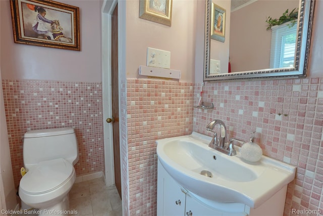 637 Arthur Ave, Pontiac, MI 48341 - half bathroom featuring tile walls, vanity, tile patterned floors, and wainscoting