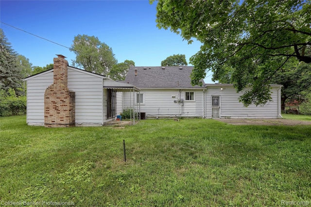 637 Arthur Ave, Pontiac, MI 48341 - back of house featuring a yard and a chimney