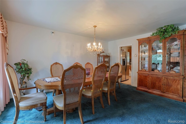 637 Arthur Ave, Pontiac, MI 48341 - dining area featuring a chandelier and dark colored carpet