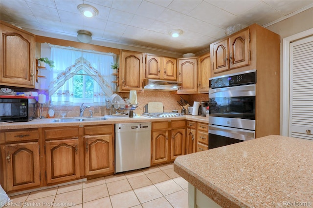 637 Arthur Ave, Pontiac, MI 48341 - kitchen featuring stainless steel appliances, under cabinet range hood, tasteful backsplash, light countertops, and light tile patterned floors