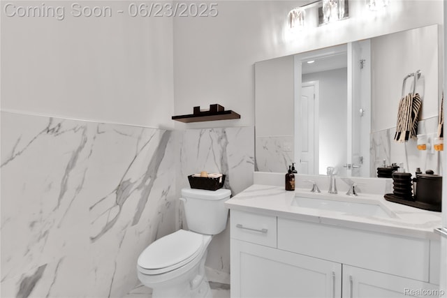 56727 Via Carlotta, Shelby Twp, MI 48042 - bathroom featuring vanity, tile walls, wainscoting, and marble finish flooring
