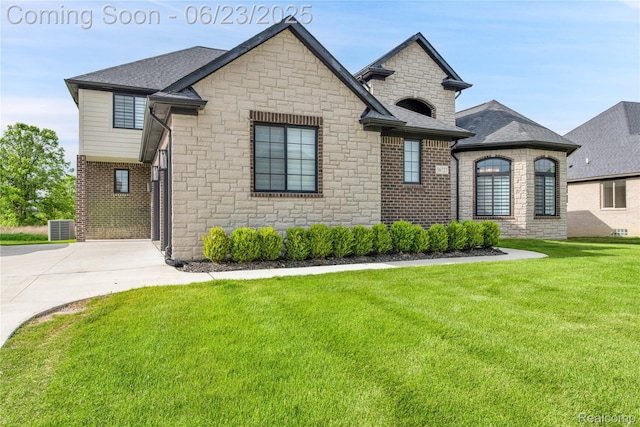 56727 Via Carlotta, Shelby Twp, MI 48042 - french provincial home featuring stone siding, a front lawn, brick siding, and a shingled roof