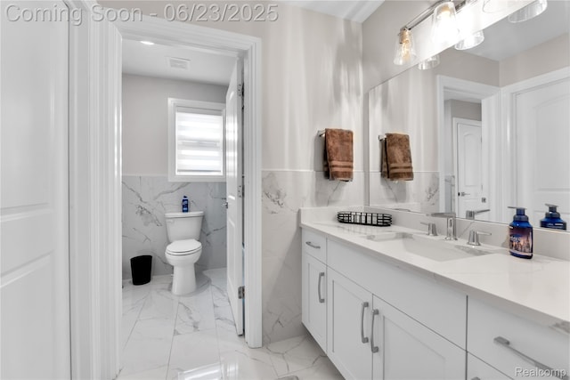 56727 Via Carlotta, Shelby Twp, MI 48042 - bathroom featuring tile walls, vanity, marble finish floors, and a wainscoted wall