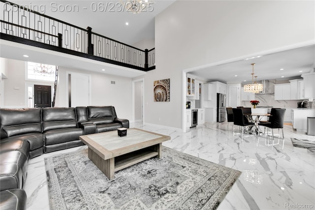 56727 Via Carlotta, Shelby Twp, MI 48042 - living room with a chandelier, beverage cooler, light marble finish flooring, a high ceiling, and recessed lighting
