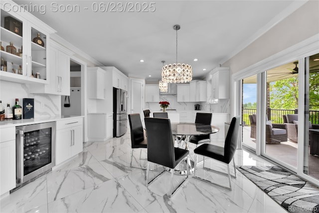 56727 Via Carlotta, Shelby Twp, MI 48042 - dining area featuring beverage cooler, a chandelier, recessed lighting, a bar, and light marble finish flooring