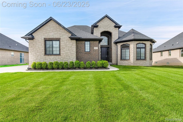 56727 Via Carlotta, Shelby Twp, MI 48042 - french country inspired facade with stone siding, a front yard, and roof with shingles