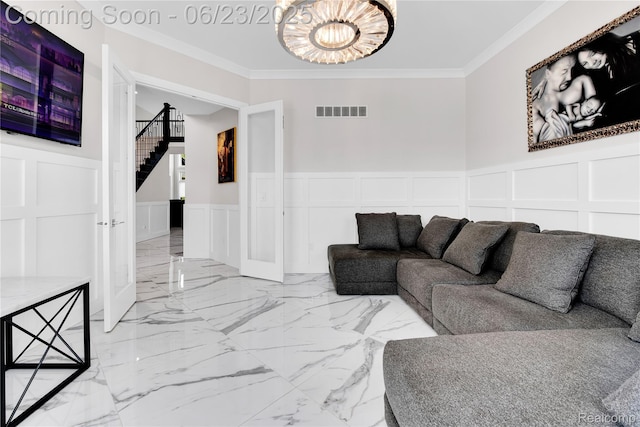 56727 Via Carlotta, Shelby Twp, MI 48042 - living area featuring a decorative wall, a chandelier, crown molding, stairs, and wainscoting
