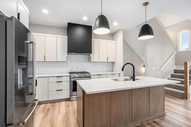 994 Harbor Dr E, Saint Joseph, MI 49085 - kitchen featuring stainless steel appliances, ventilation hood, light wood-style flooring, backsplash, and recessed lighting