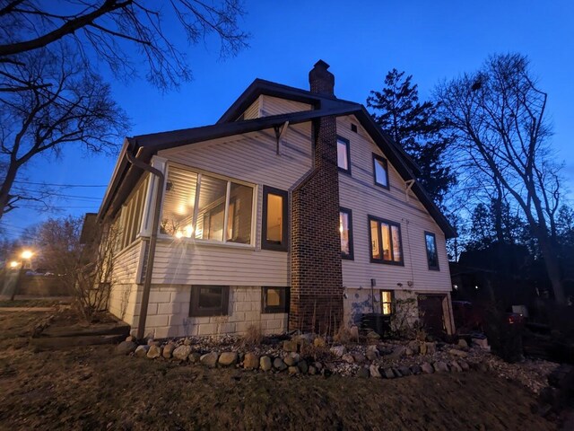 539 Sunset Ln, East Lansing, MI 48823 - view of property exterior with a chimney
