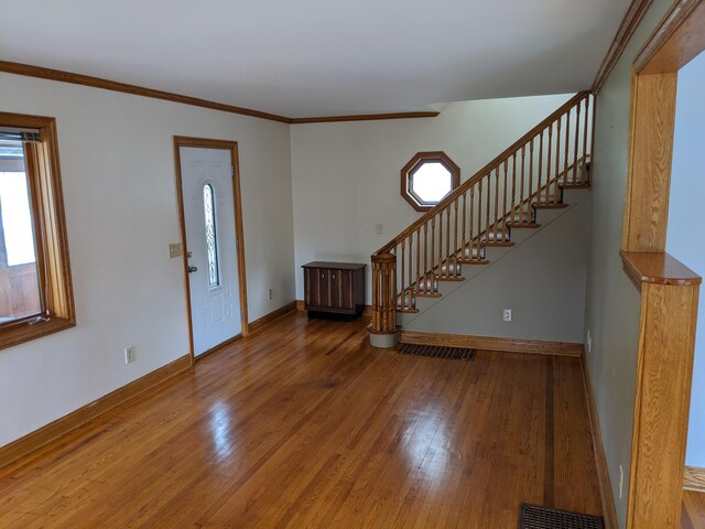 539 Sunset Ln, East Lansing, MI 48823 - entrance foyer featuring wood-type flooring, stairway, and crown molding