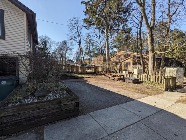 539 Sunset Ln, East Lansing, MI 48823 - view of yard with a patio area and asphalt driveway