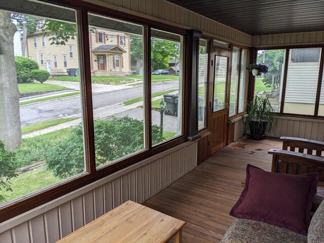 539 Sunset Ln, East Lansing, MI 48823 - sunroom / solarium featuring wood-type flooring and wooden walls