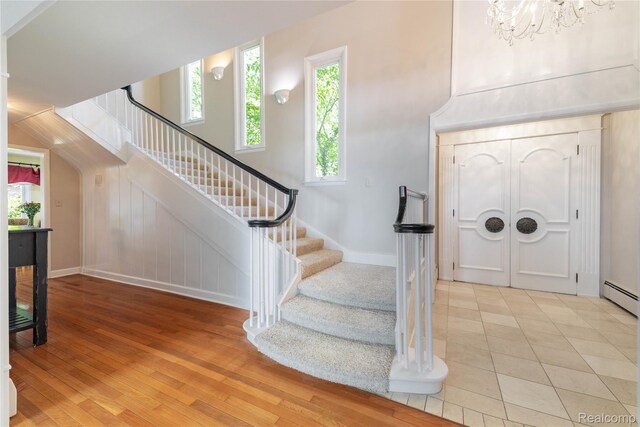 19891 Parke Ln, Grosse Ile, MI 48138 - entryway featuring stairs, a chandelier, and light wood finished floors