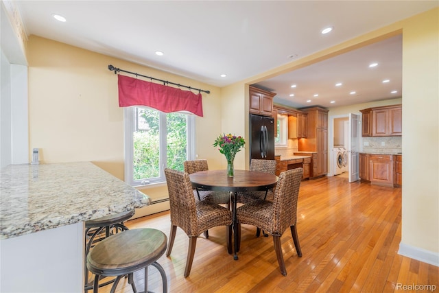 19891 Parke Ln, Grosse Ile, MI 48138 - dining area featuring washer / clothes dryer, light wood finished floors, recessed lighting, and a baseboard radiator