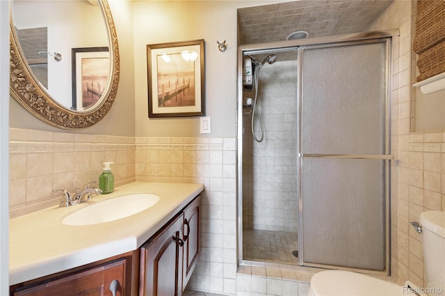 19891 Parke Ln, Grosse Ile, MI 48138 - full bathroom with tile walls, a shower stall, vanity, and a wainscoted wall
