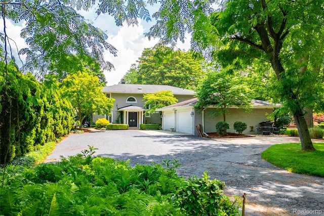 19891 Parke Ln, Grosse Ile, MI 48138 - obstructed view of property featuring asphalt driveway and a garage