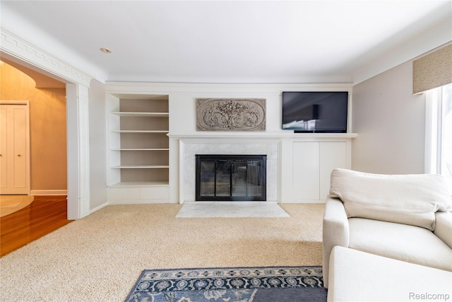 19891 Parke Ln, Grosse Ile, MI 48138 - living room featuring built in shelves, a fireplace, and carpet flooring