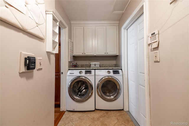 19891 Parke Ln, Grosse Ile, MI 48138 - laundry area featuring washing machine and dryer, cabinet space, and light tile patterned floors